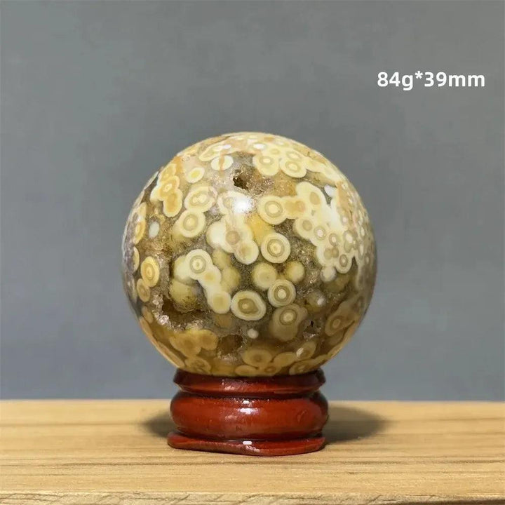 Ocean Jasper sphere from Crystal Destiny, 39mm, with unique cream, white, and yellow orbicular patterns on a red base.