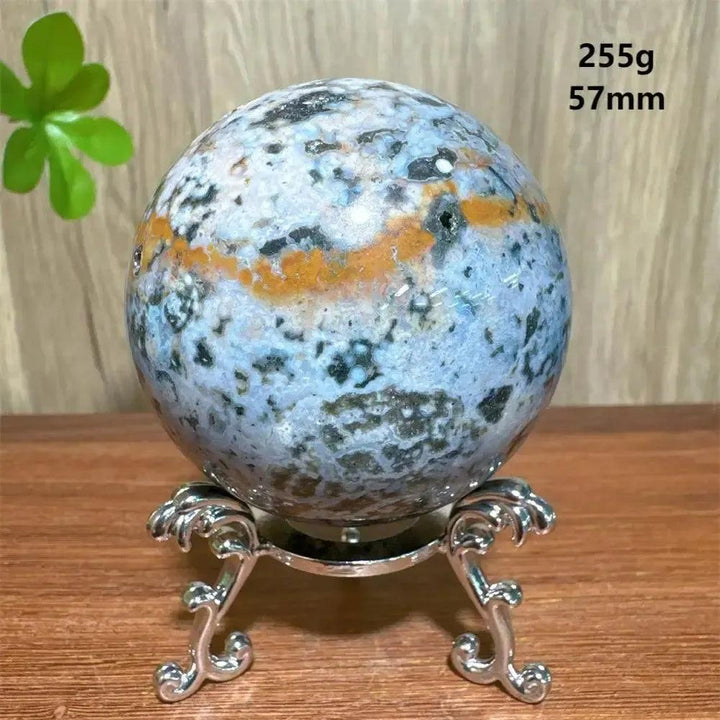 Ocean Jasper sphere from Crystal Destiny, 57mm, 255g, with blue, orange, and black orbicular patterns on a silver stand.