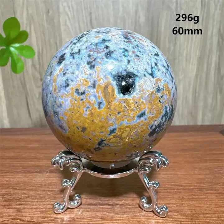 Ocean Jasper sphere, 60mm, 296g, with blue, gold, and black patterns on a silver stand from Crystal Destiny.