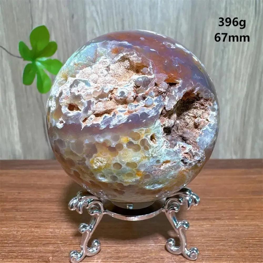 Ocean Jasper sphere from Crystal Destiny, featuring unique orbicular patterns, greens, whites, pinks, and browns on a silver stand.