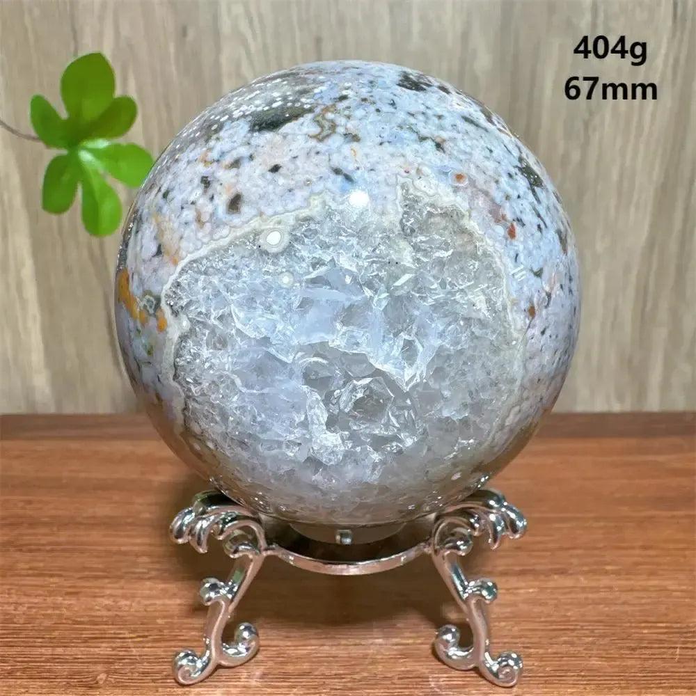 Ocean Jasper sphere from Crystal Destiny, 67mm, 404g, with orbicular patterns and a clear druzy cavity on a silver stand.