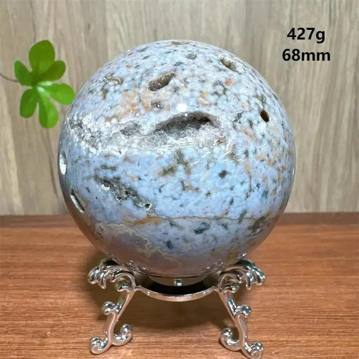 Ocean Jasper sphere from Crystal Destiny, 68mm, 427g, with natural druzy pockets on a silver stand.