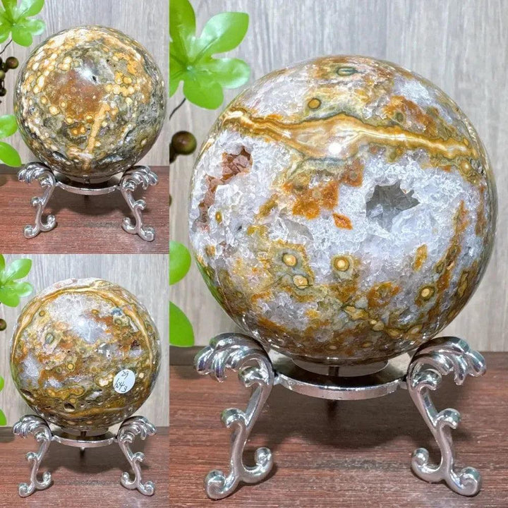 Ocean Jasper sphere with white, green, brown, and orange orbicular patterns on a silver stand from Crystal Destiny.