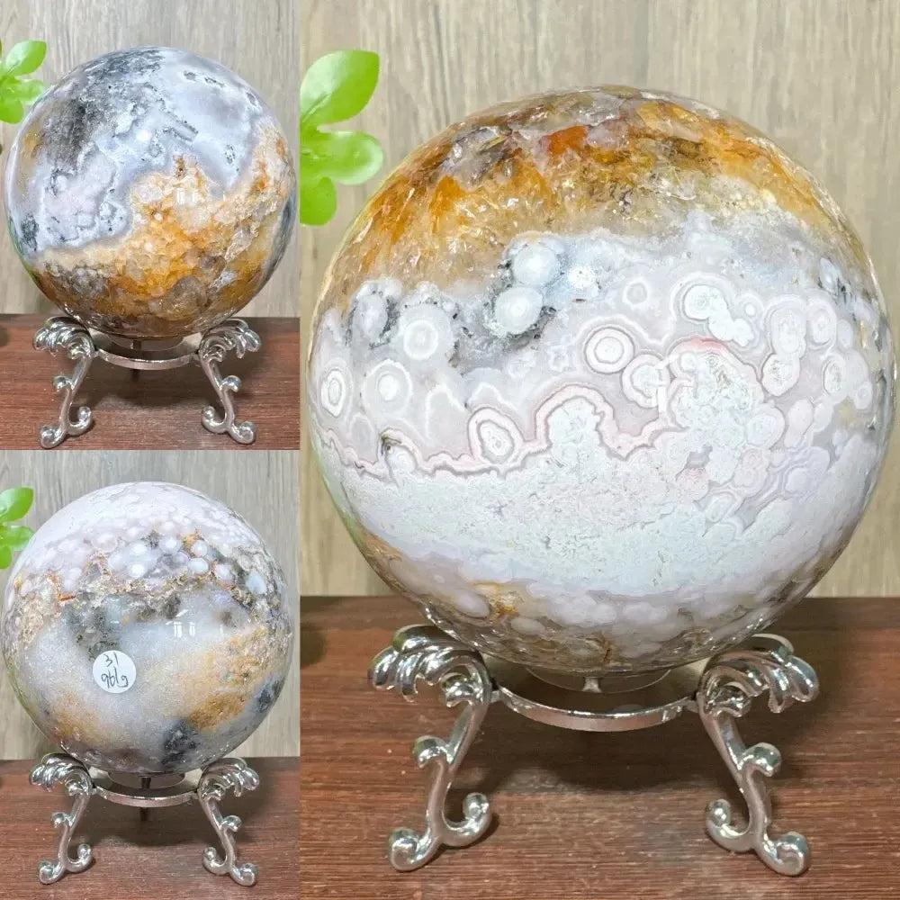 Ocean Jasper sphere from Crystal Destiny, featuring unique orbicular patterns in greens, whites, pinks, and browns on a stand.