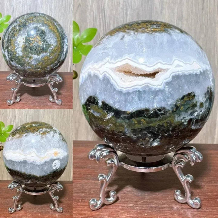 Ocean Jasper sphere from Crystal Destiny, featuring unique green, white, and brown orbicular patterns on a silver stand.