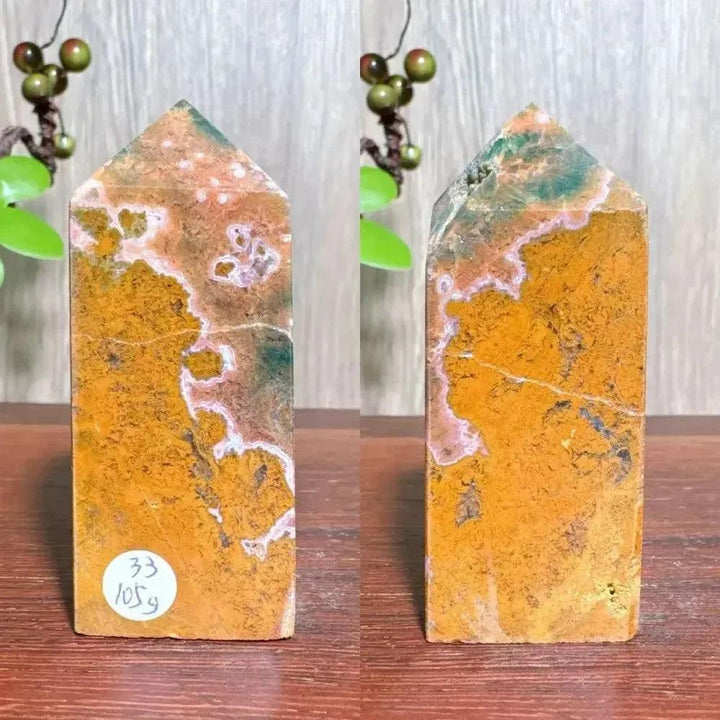Polished Ocean Jasper tower with vibrant orange, green, and white swirling patterns, ideal for Heart and Throat Chakra healing.