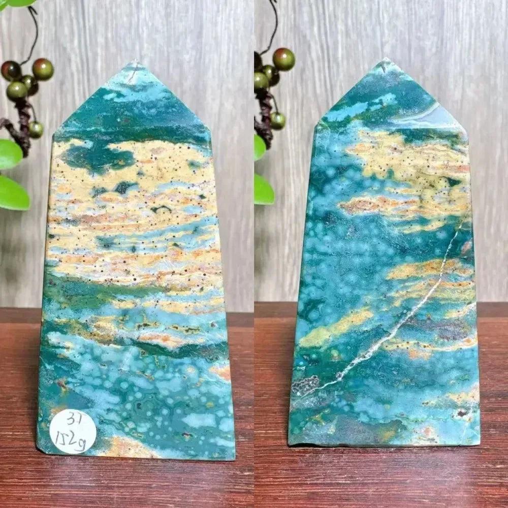 Polished blue Ocean Jasper tower with swirling orb patterns, cream, and green tones, and natural druzy inclusions.