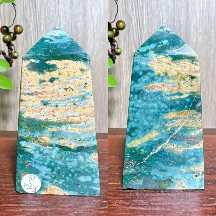 Polished blue Ocean Jasper tower with swirling orb patterns, cream, and green tones, and natural druzy inclusions.