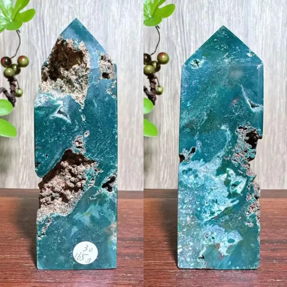 Polished blue Ocean Jasper tower with swirling patterns, natural druzy inclusions, and a pointed top.