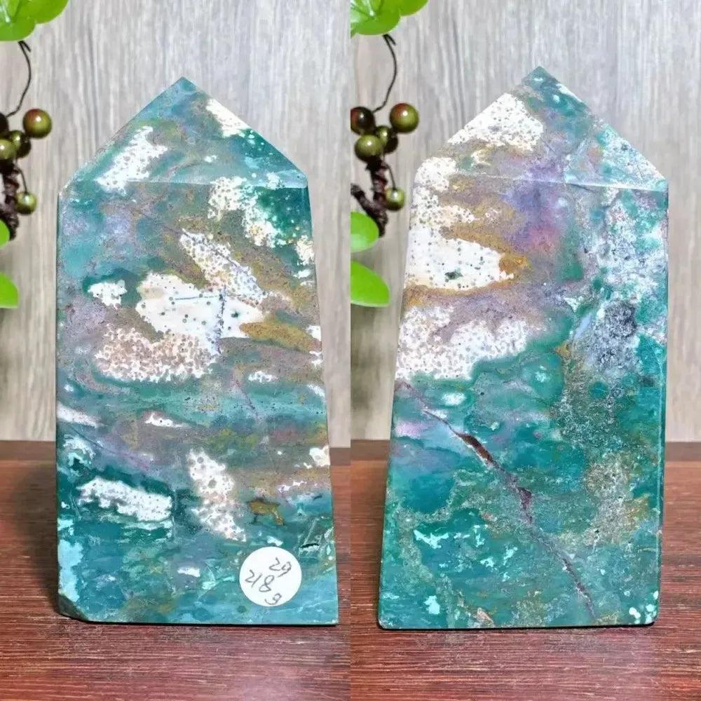 Polished blue Ocean Jasper tower with swirling green, cream, and purple patterns, featuring sparkling Moss Agate druzy.