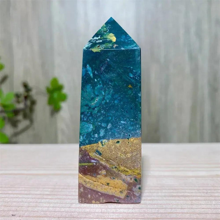 Polished Ocean Jasper tower with swirling blue, green, and yellow patterns, ideal for Heart and Throat Chakra healing.