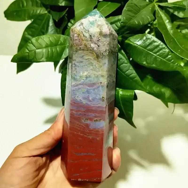 Polished Ocean Jasper tower point featuring vibrant red, blue, and orbicular bands for Heart and Throat Chakra healing.
