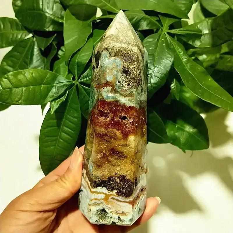 Polished Ocean Jasper tower point featuring vibrant orbicular patterns and earthy bands for heart chakra healing.
