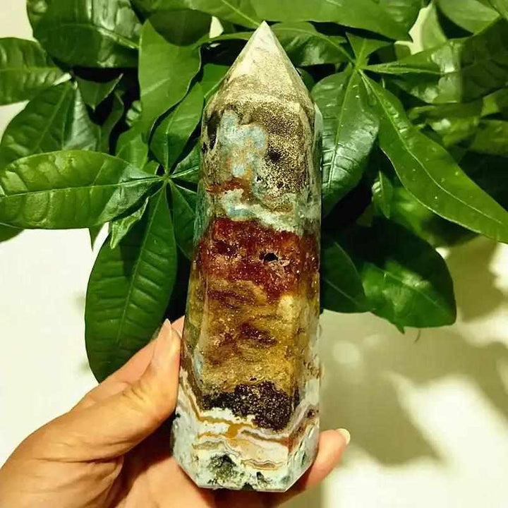 Polished Ocean Jasper tower point featuring vibrant orbicular patterns and earthy bands for heart chakra healing.
