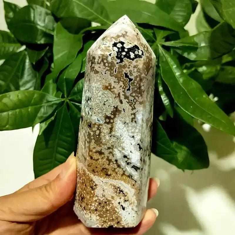 Polished Ocean Jasper tower point featuring intricate orb patterns and earthy tones for heart chakra healing and display.