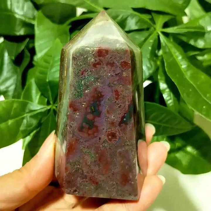 Polished Ocean Jasper tower point featuring vibrant red and green orbicular patterns for heart chakra healing.