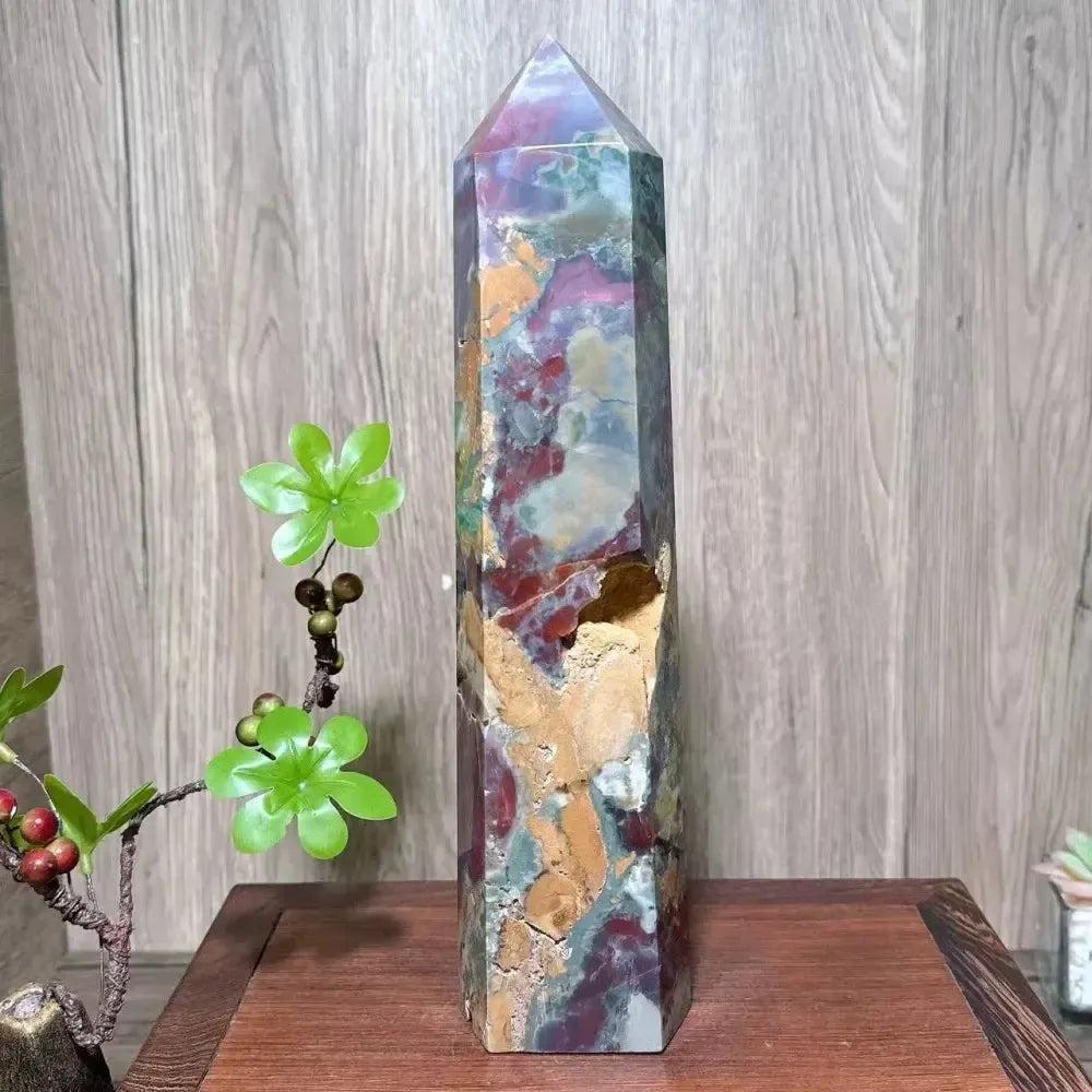 Large Ocean Jasper tower from Crystal Destiny, featuring orbicular patterns in green, yellow, cream, and earthy tones.