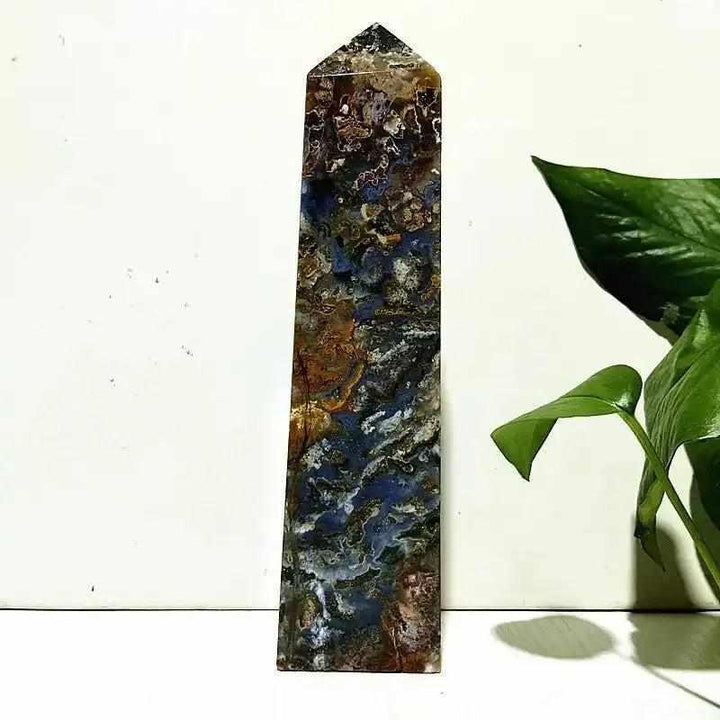 Polished Ocean Jasper tower wand featuring intricate blue, brown, and cream orb patterns for heart chakra healing.