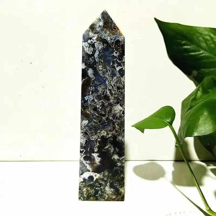 Polished Ocean Jasper tower wand featuring intricate blue and dark orbicular patterns for Heart Chakra healing and decor.