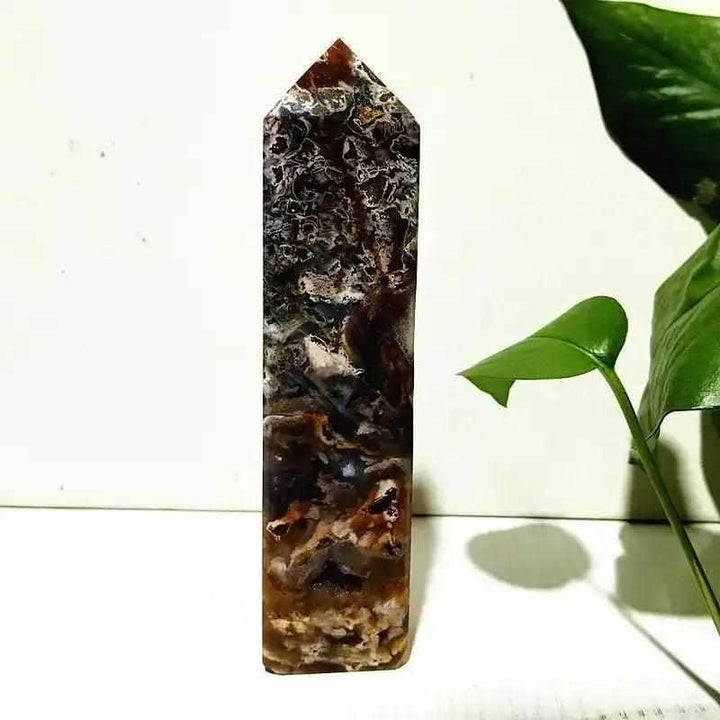 Polished Ocean Jasper tower wand featuring intricate dark banding and orb patterns for heart chakra healing and tranquility.