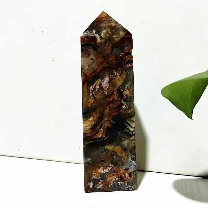Polished Ocean Jasper tower wand featuring intricate earthy banding and orb patterns for Heart Chakra healing and decor.
