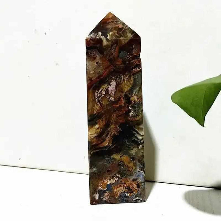 Polished Ocean Jasper tower wand featuring intricate earthy banding and orb patterns for Heart Chakra healing and decor.