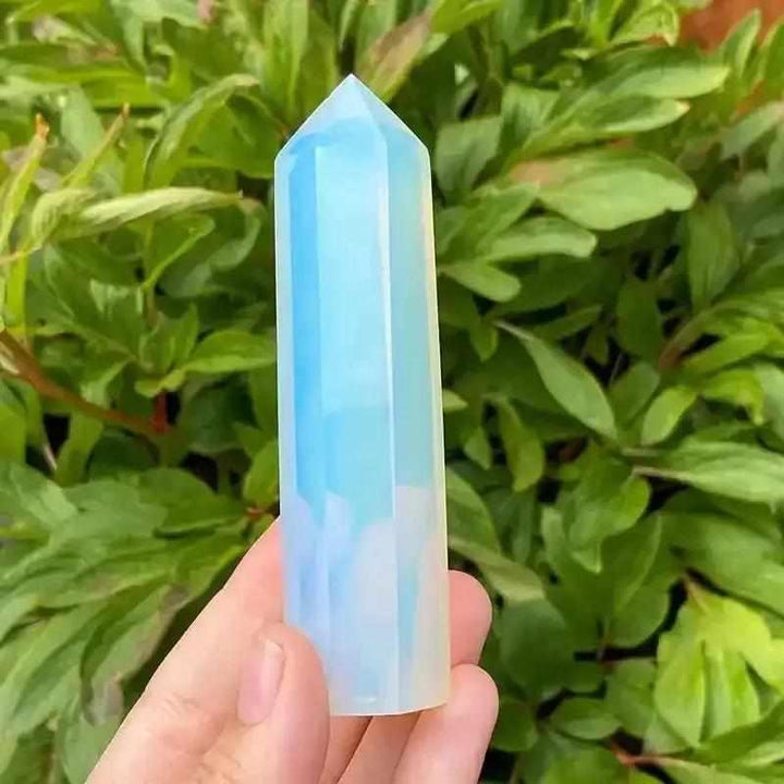 Polished opalite obelisk tower with a milky, iridescent blue glow, perfect for Third Eye Chakra meditation and decor.