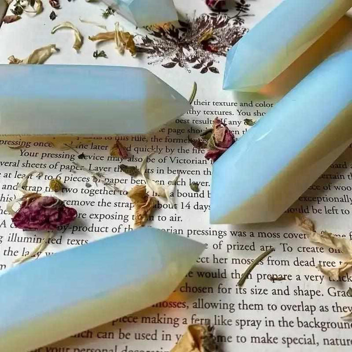 Polished opalite obelisk tower with a milky glow and blue shimmer, perfect for Third Eye Chakra meditation and altars.