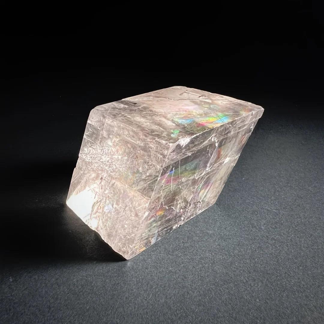 Clear Brazilian Optical Calcite cube with rainbow refractions, ideal for home decor and promoting clarity.