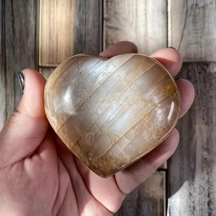 Crystal Destiny's radiant orange moonstone heart, glowing with peachy-orange tones and iridescent shimmer.