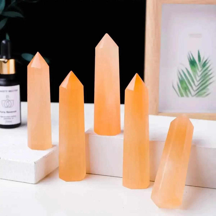 Polished Orange Selenite Tower crystal point with silky peach fibers for sacral chakra cleansing and creative energy.