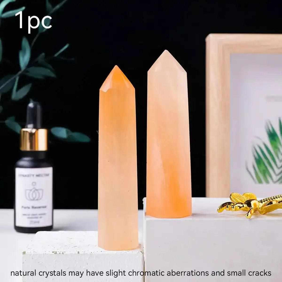 Polished orange selenite tower point with silky fibers, perfect for sacral chakra healing and warm, creative home decor.