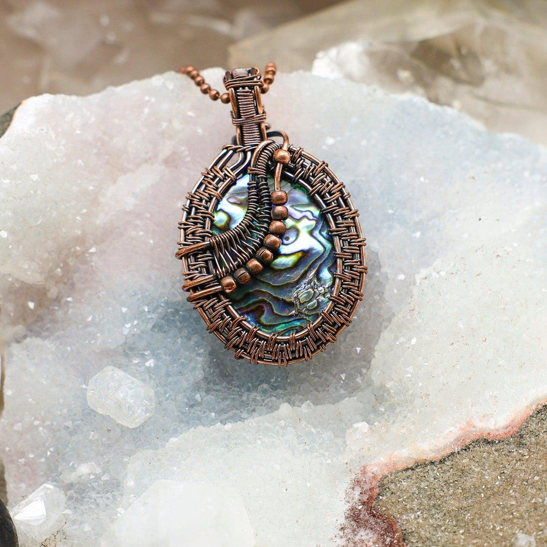 Paua Abalone Shell Wire Wrap Pendant with iridescent blue, green, purple, and pink hues in healing copper.