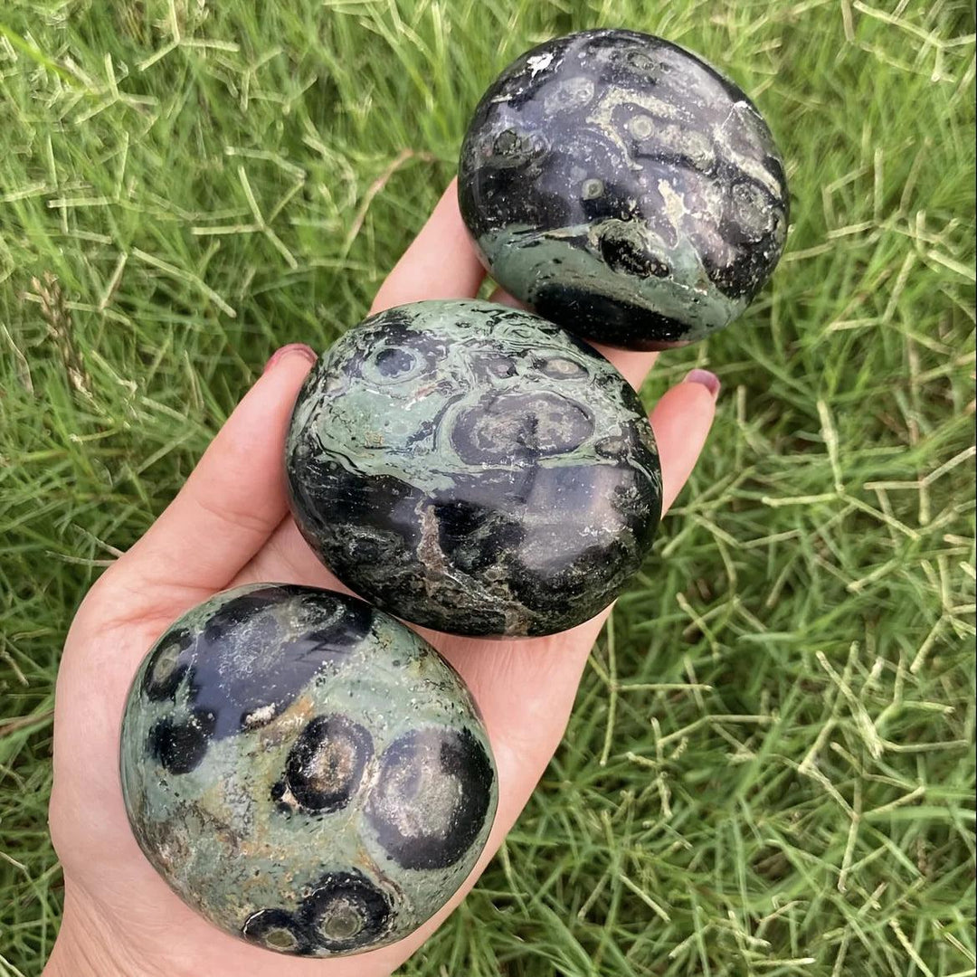 Peacock Eye Crystal Polished Palm Stones with green and black chatoyant patterns for grounding and protection.