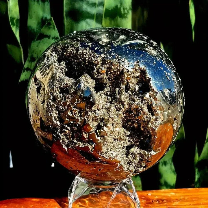 Peruvian Pyrite Crystal Ball: Polished metallic gold sphere with sparkling cubic crystal inclusions, radiating abundance.