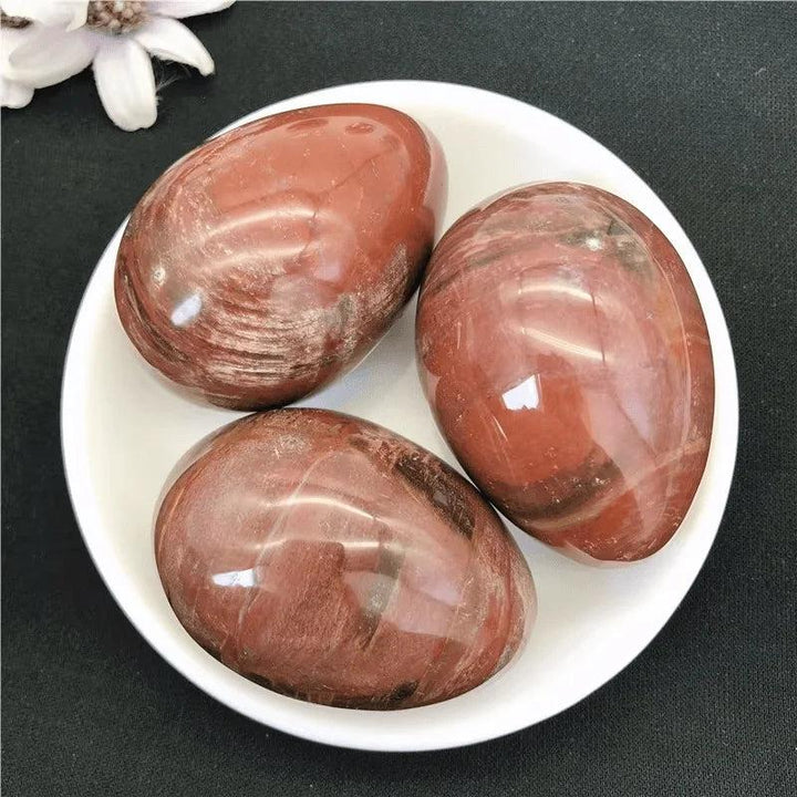 Polished reddish-brown Petrified Wood Crystal Egg Stones for grounding and root chakra healing.