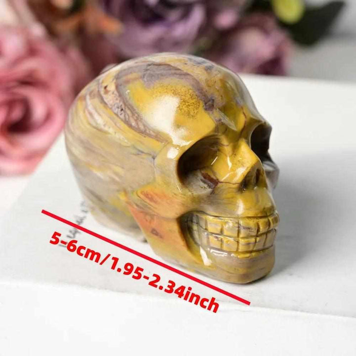 60mm hand-carved petrified wood skull with warm brown and tan grain, perfect for root chakra grounding and home decor.