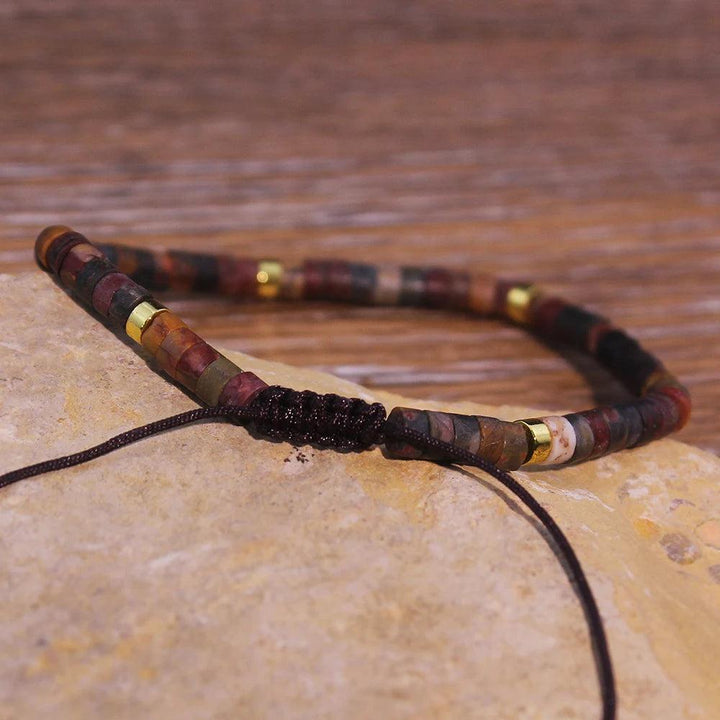 Picasso Jasper Crystal Beaded Adjustable Woven Bracelet with dark, sweeping markings and gold accents, offering grounding & stability.