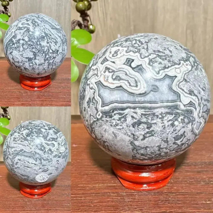 Picasso Jasper Sphere: Polished gray, black, brown, and cream sphere with abstract patterns on a red stand.