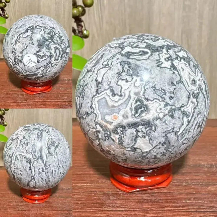 Polished Picasso Jasper Sphere with abstract gray, black, and cream patterns on a red stand, promoting creativity and grounding.