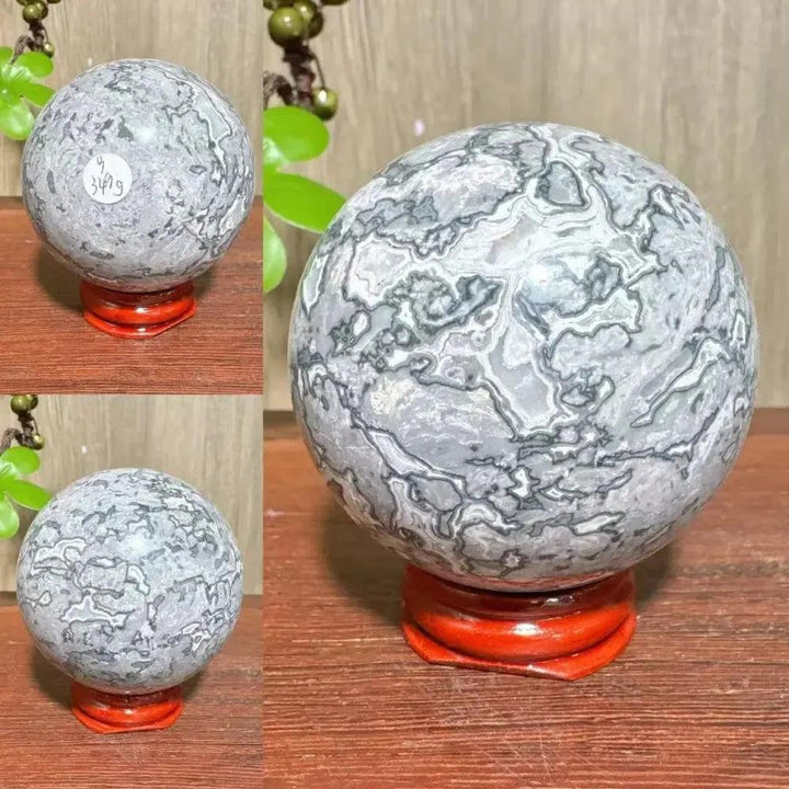 Crystal Destiny Picasso Jasper sphere, gray, black, brown, cream abstract patterns on a red stand.