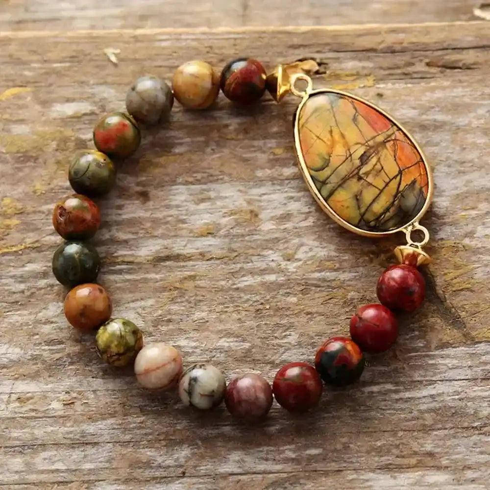 Picasso Jasper stretch bracelet with 8MM earthy-toned beads and a gold-framed teardrop pendant from Crystal Destiny.