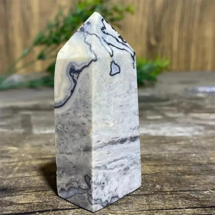 Picasso Stone Crystal Tower with bold black brushstrokes on warm cream, grounding Root Chakra stone.