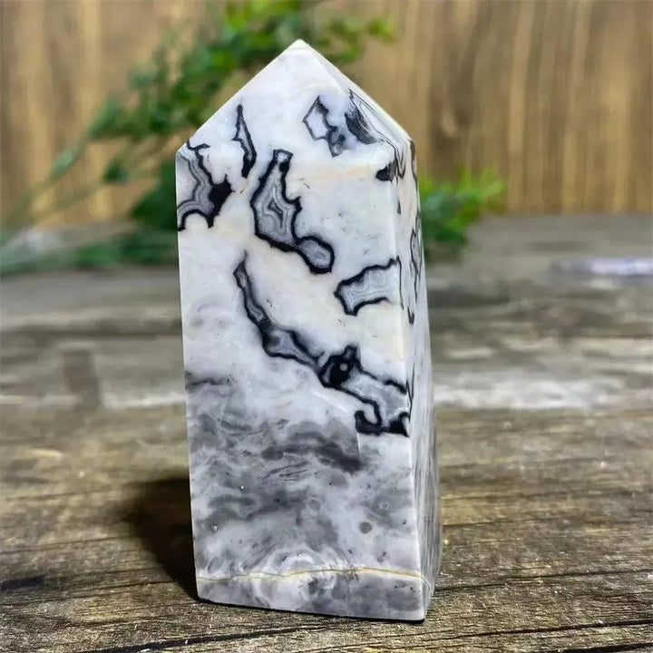 Picasso Stone Crystal Tower with bold black brushstrokes on warm cream, a grounding Root Chakra stone.