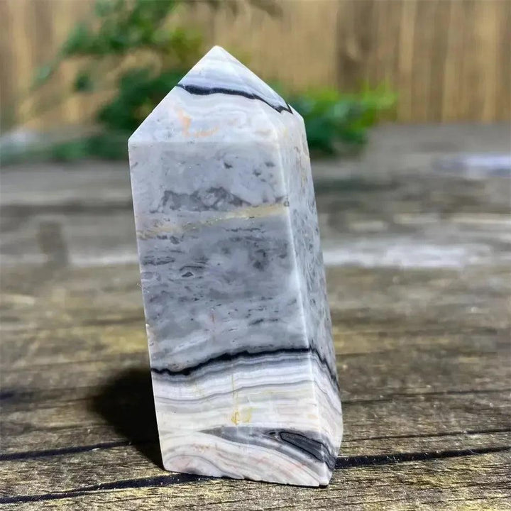 Picasso Stone Crystal Tower with bold black brushstrokes on warm cream, grounding Root Chakra stone.