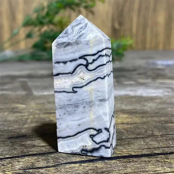 Picasso Stone Crystal Tower with bold black brushstrokes on warm cream, a grounding Root Chakra stone.