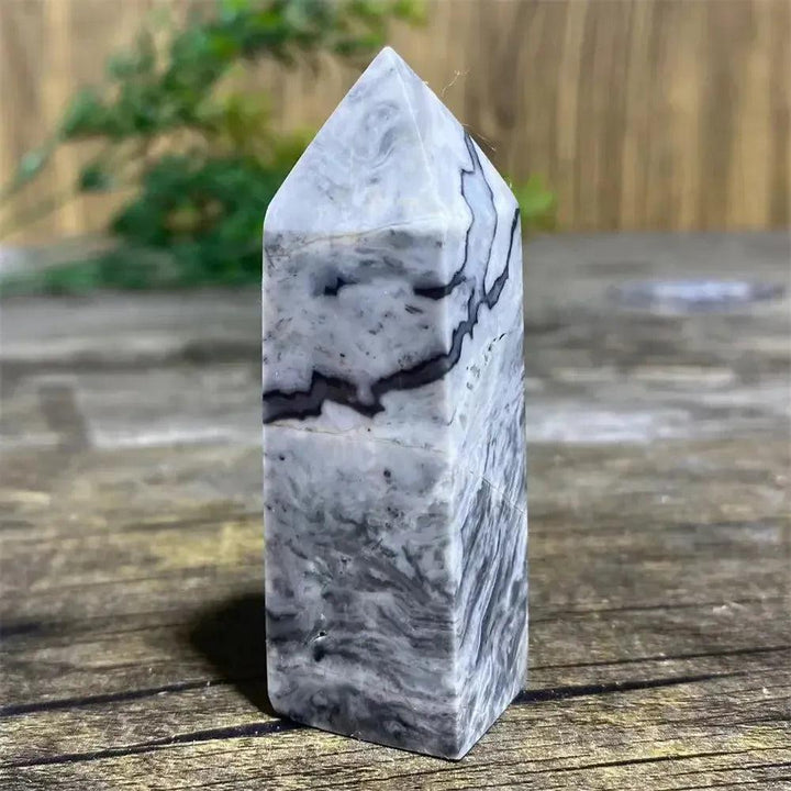 Picasso Stone Crystal Tower with bold black brushstrokes on warm cream, grounding Root Chakra stone.