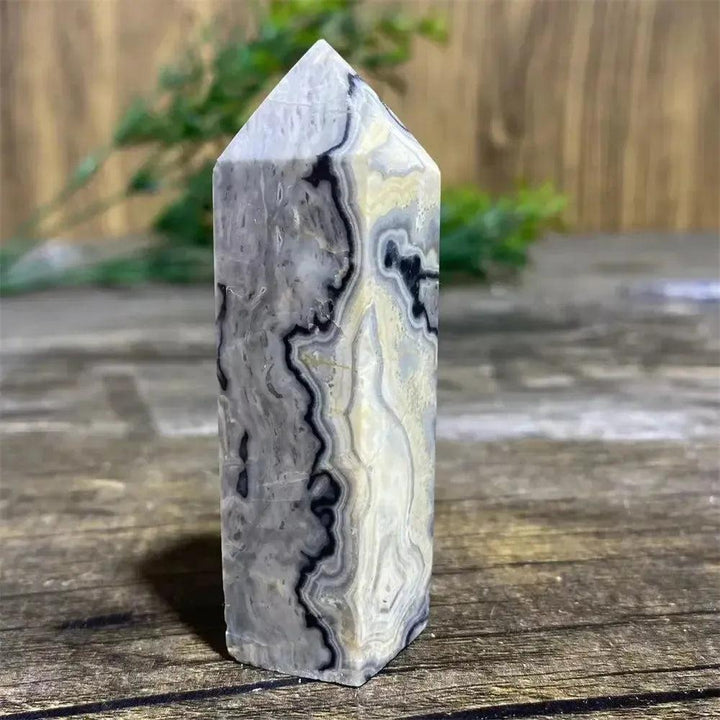 Picasso Stone Crystal Tower with bold black brushstrokes on warm cream, a grounding Root Chakra stone.