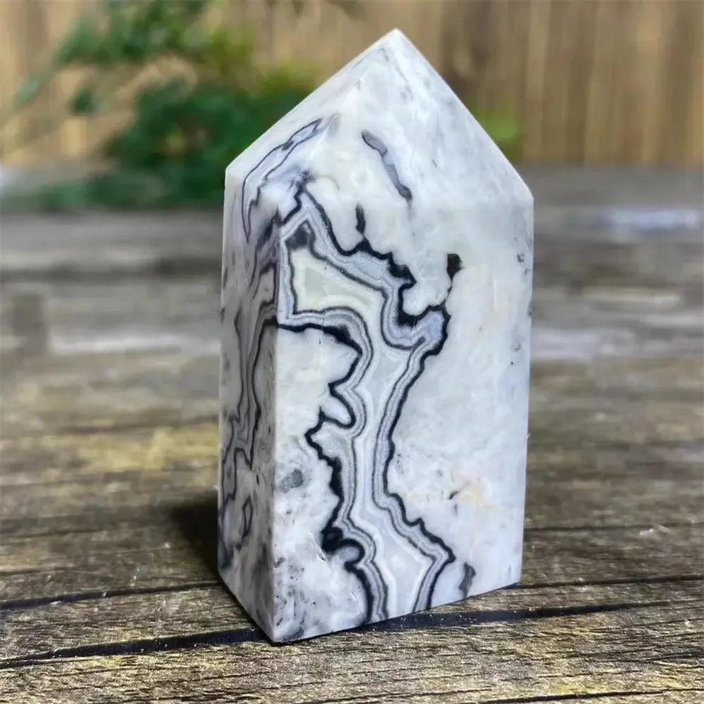 Picasso Stone Crystal Tower with bold black brushstrokes on warm cream, grounding Root Chakra stone.