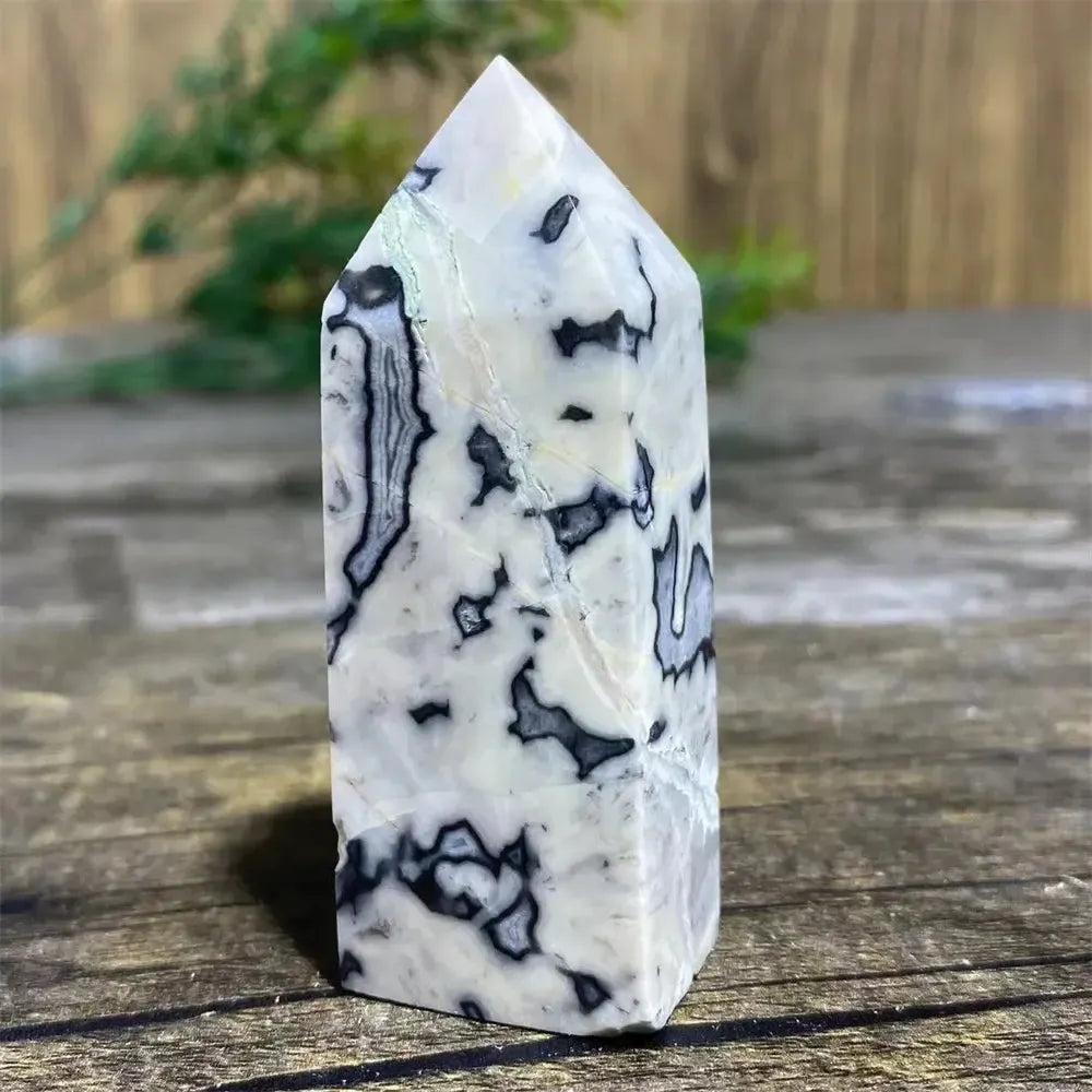 Picasso Stone Crystal Tower: grounding root chakra stone with bold black brushstrokes on warm cream.